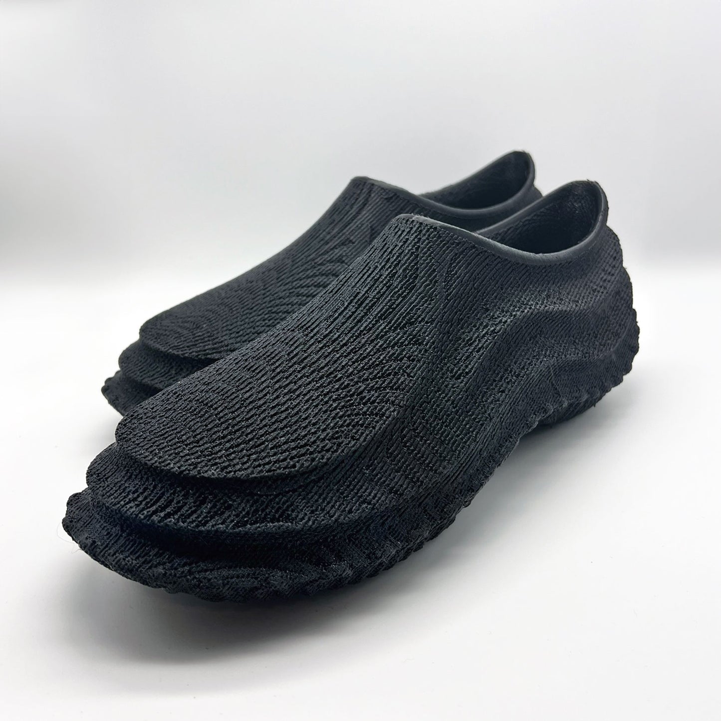 a pair of 3D printed 16 kw shoes techno graphite color