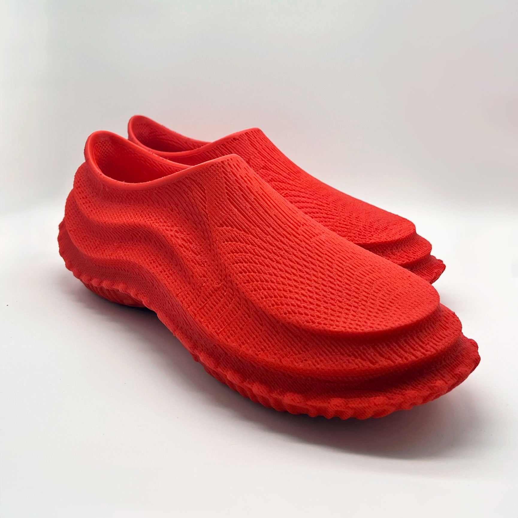 a pair of 3D printed 16 kw shoes red pill color